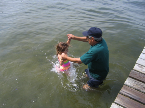 Jumping off the dock into the water. 