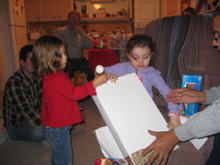 The girls helped each other rip into gifts.