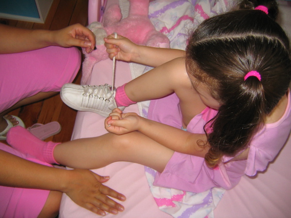 Learning to tie her shoes....