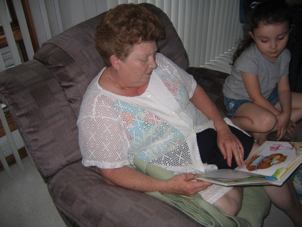 Grandma reading her a story.