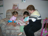 Grandma reading with the girls. 