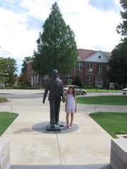 Novali standing next to statue of James Meredeth. 